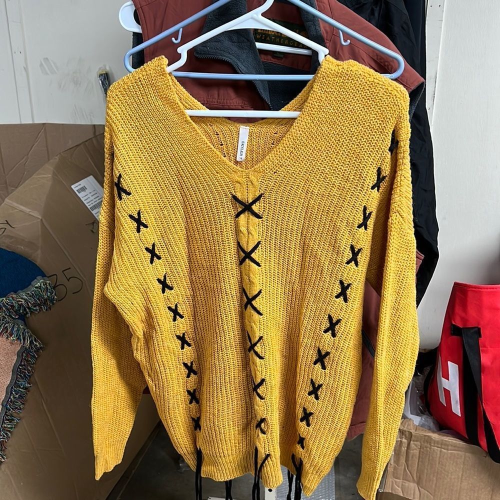New woman’s yellow and black sweater